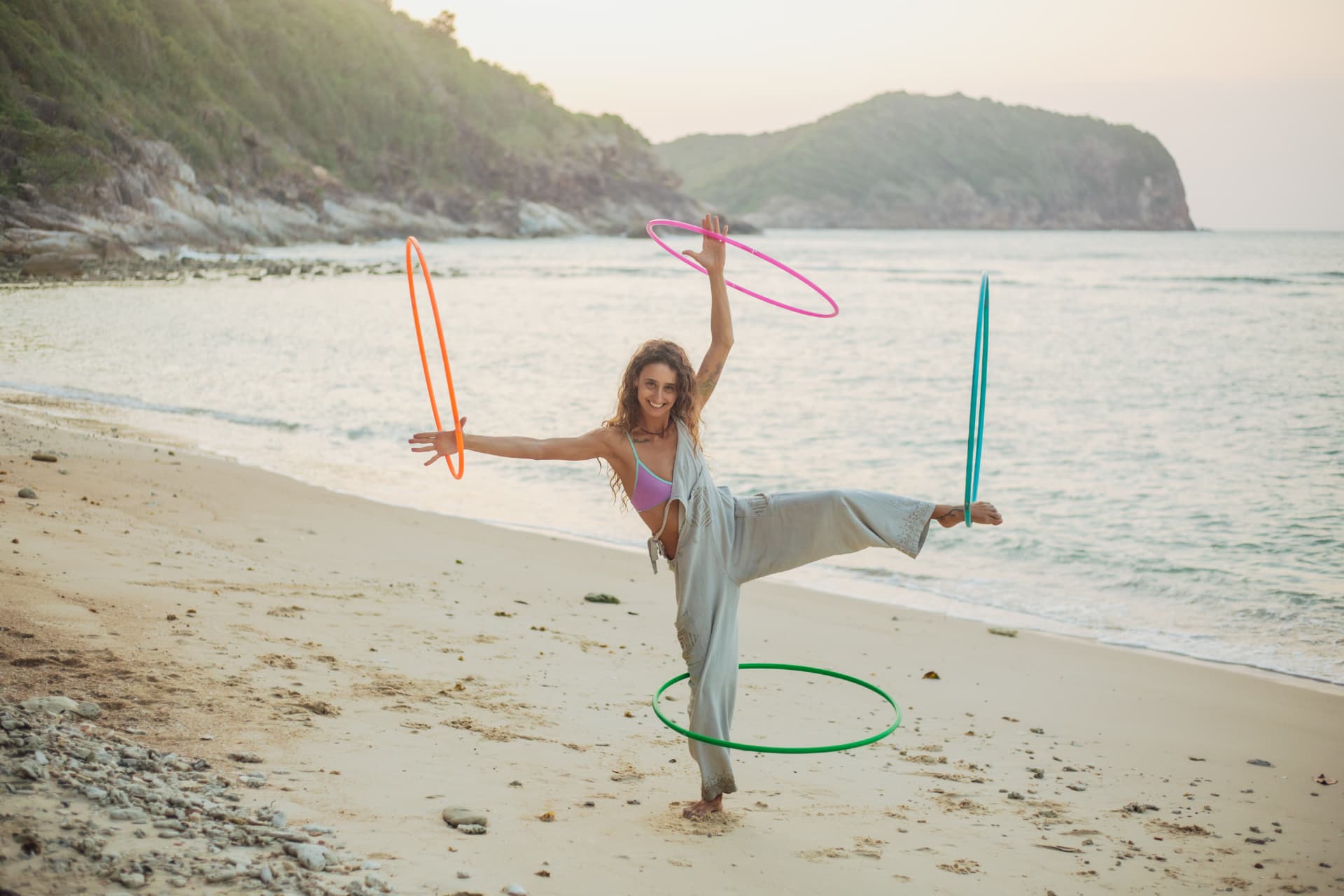 Soof flowing with hoops on the beach at sunrise