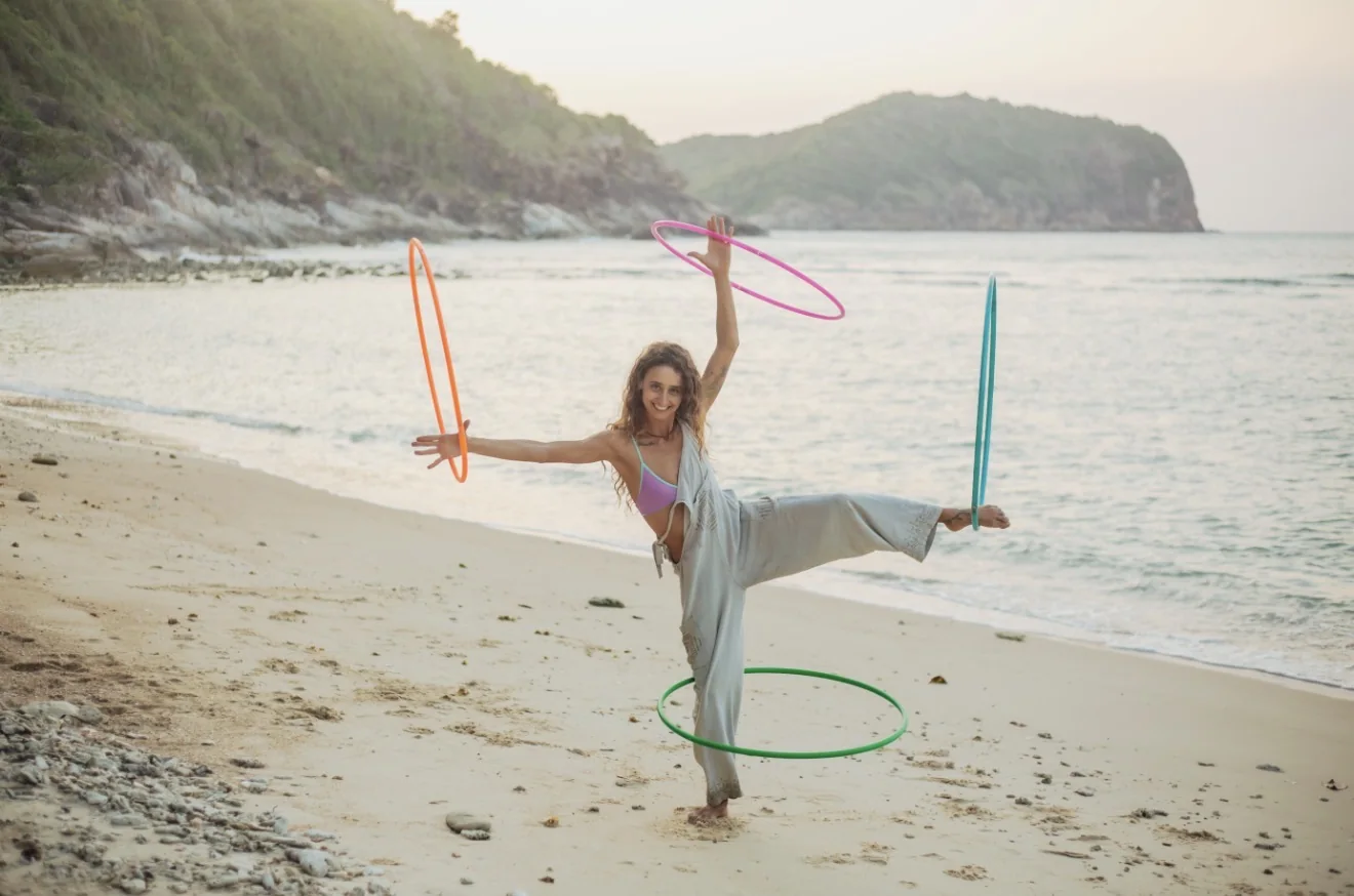 Soof on the beach with a pink hula hoop at golden hour