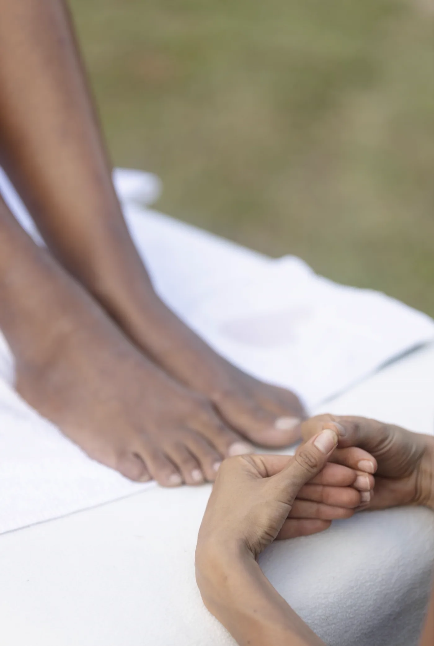 A close detail of feet resting on a white towel